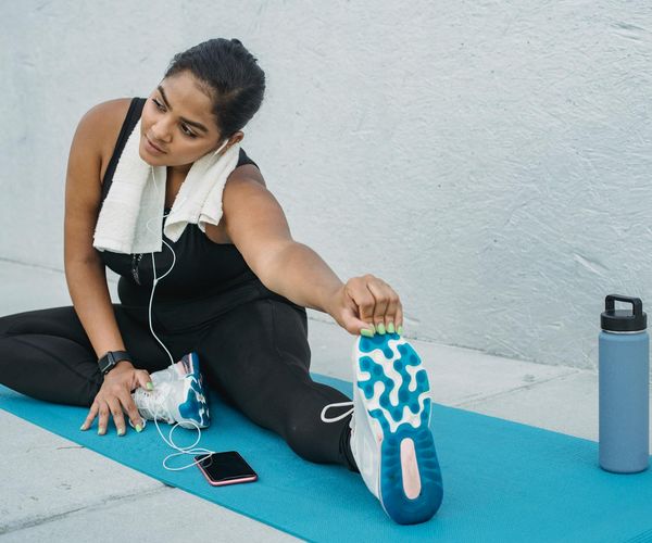Yoga mat, water bottle, and a small towel neatly arranged on a floor.